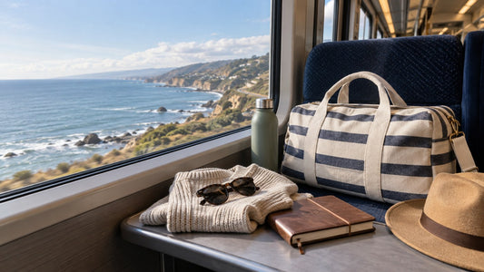 a striped canvas duffle bag beside a coastal train journey with a weekend outfit and travel journal