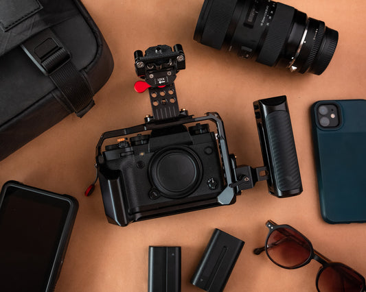 Flat lay of a camera surrounded by organized camera equipment