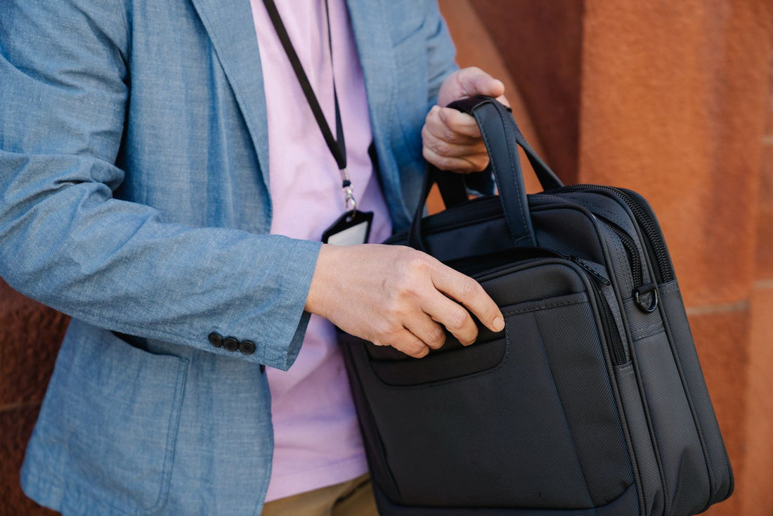 Professional holding a classic leather briefcase in a blue blazer