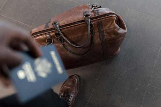 Brown leather duffle bag with brass hardware for stylish travel