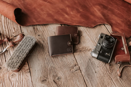 Handcrafted leather wallets with card slots laid on a wooden surface