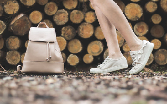 Stylish woman with a leather backpack in urban setting, modern lifestyle