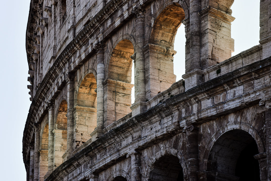 Close-up view of the historic Colosseum in Rome, Italy at sunset, ancient architecture