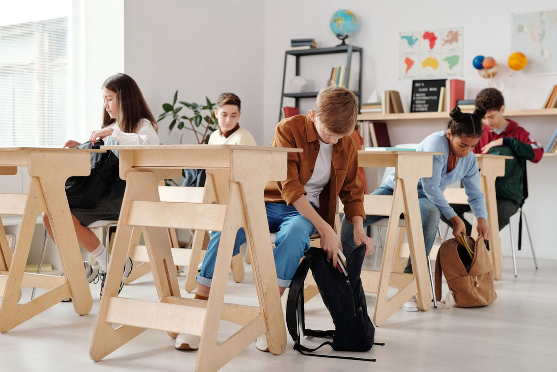 Students at classroom desks with school backpacks for daily use