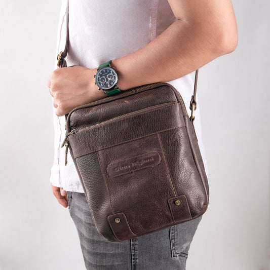 Vintage leather sling bag worn as everyday carry