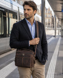 Full-grain leather iPad crossbody bag worn by model in an urban commute setting