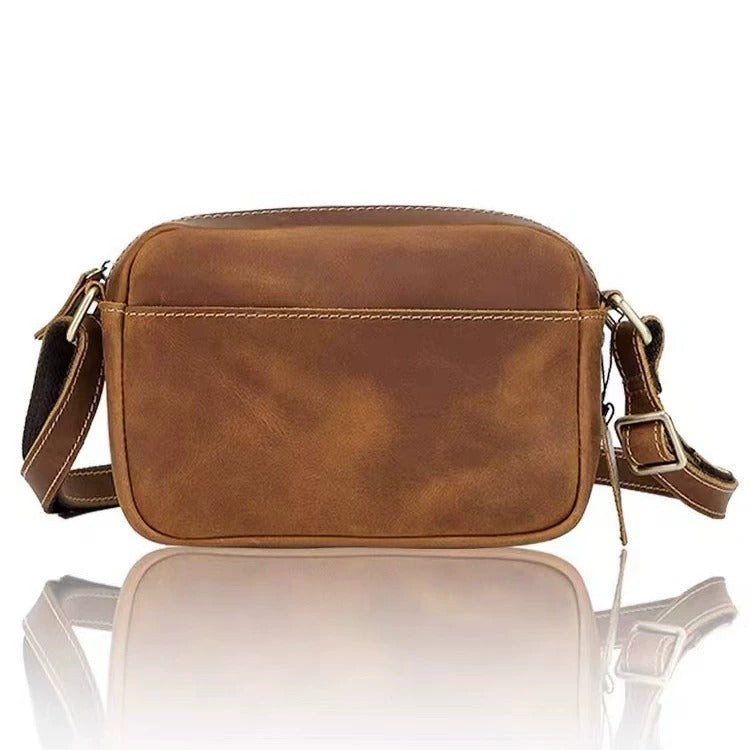 Full-grain leather multi-pocket crossbody bag on white background