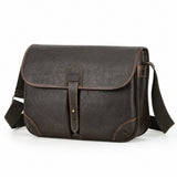 Vintage leather messenger bag closure and stitching detail