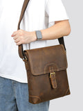 Vintage leather messenger bag worn front view