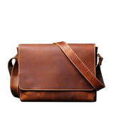Vintage full-grain leather messenger bag on white background